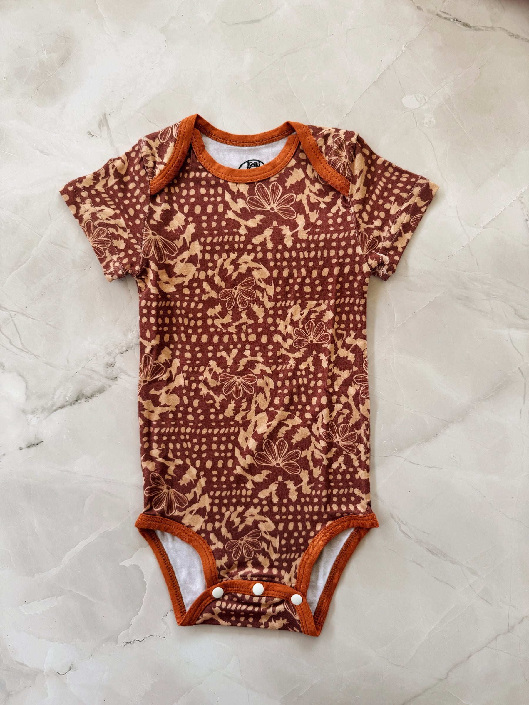 Naupaka shell onesie
